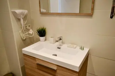 a bathroom with a white sink and a mirror at Hola Valencia - Holiday Apartments in Valencia