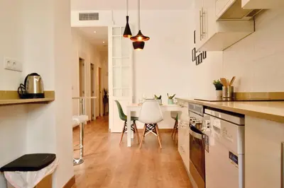 a kitchen with a table and chairs in it at Hola Valencia - Holiday Apartments in Valencia