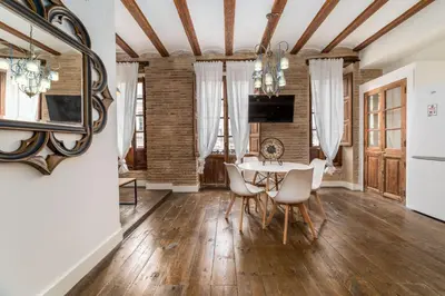 a dining room with a table and chairs and a mirror at My Loft 4 You Ruzafa Style II in Valencia