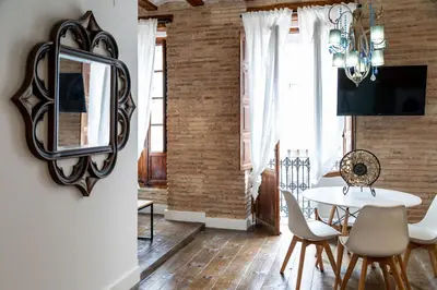a dining room with a white table and chairs at My Loft 4 You Ruzafa Style II in Valencia