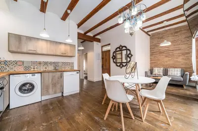a kitchen and living room with a table and chairs at My Loft 4 You Ruzafa Style II in Valencia