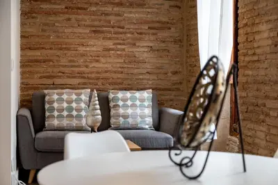 a living room with a couch and a brick wall at My Loft 4 You Ruzafa Style II in Valencia