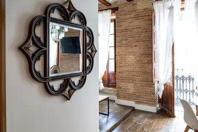 a mirror hanging on a wall next to a room at My Loft 4 You Ruzafa Style II in Valencia