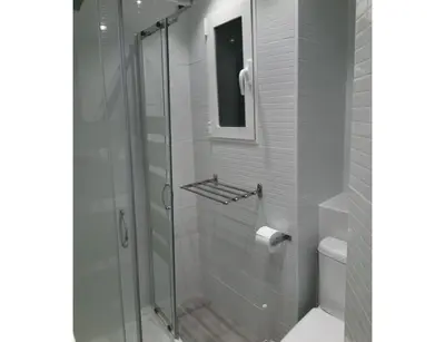 a glass shower in a bathroom with a toilet at Malvarossa apartment near beach in Valencia