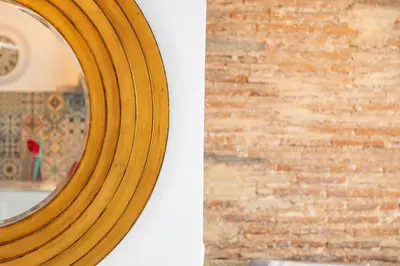 a wooden mirror leaning against a brick wall at My Loft 4 You Ruzafa Style III in Valencia