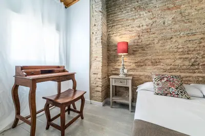 a bedroom with a bed and a table with a lamp at My Loft 4 You Ruzafa Style III in Valencia