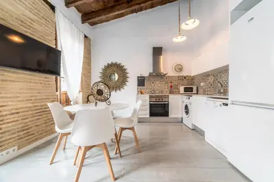 a kitchen with a white table and white chairs at My Loft 4 You Ruzafa Style III in Valencia