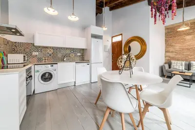 a kitchen with a white table and white chairs at My Loft 4 You Ruzafa Style III in Valencia