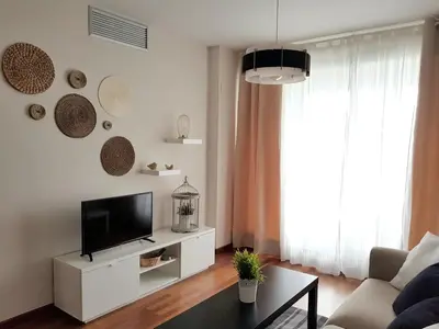a living room with a tv and a couch at River Park Valencia in Valencia