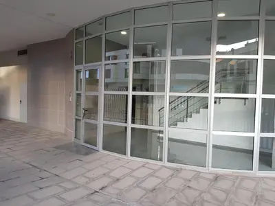 an empty building with glass windows and a staircase at River Park Valencia in Valencia