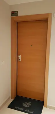 a wooden door in a room with a rug at River Park Valencia in Valencia