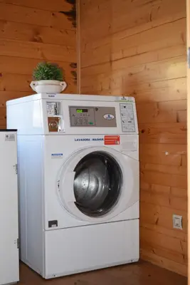a washer and dryer with a plant on top of it at Bungalows Park Albufera in El Saler