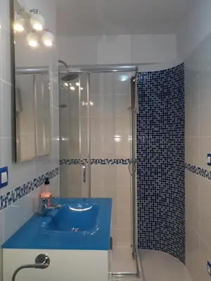 a bathroom with a blue sink and a shower at Belchite in Valencia
