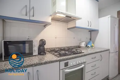 a kitchen with a stove and a microwave at Holiday Apartment Patacona Beach in Valencia