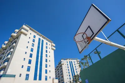 a basketball hoop in front of a tall building at Holiday Apartment Patacona Beach in Valencia
