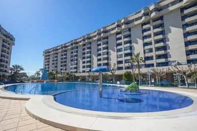 a large apartment building with a large swimming pool at Holiday Apartment Patacona Beach in Valencia