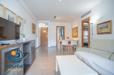 a living room with a couch and a table at Holiday Apartment Patacona Beach in Valencia