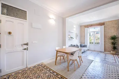 a kitchen and dining room with a table and chairs at Casa Nolla in Valencia