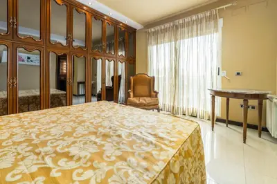 a bedroom with a bed and a desk and a chair at Travel Habitat Ático Ciutat Vella. in Valencia