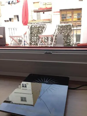 a book sitting on a table next to a window at Valencian Dreams in Valencia