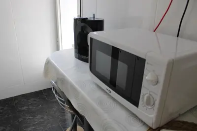 a white microwave oven sitting on top of a table at María montessori, pedagoga in Valencia