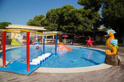 a pool in a park with a playground with aitatingitatingitatingitatingitatingitating at María montessori, pedagoga in Valencia