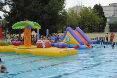a pool with a water park with a water slide at María montessori, pedagoga in Valencia