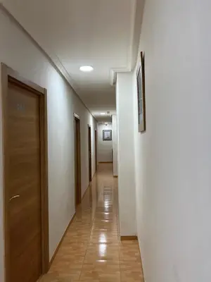 a long hallway with a door and a hallwayngth at Hospederia del Pilar in Valencia
