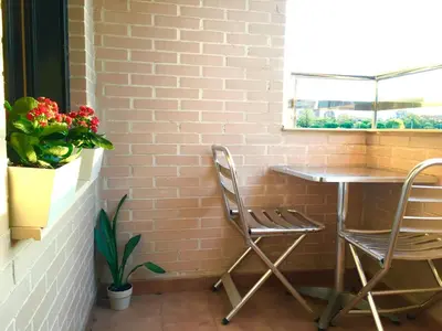 a table and two chairs next to a brick wall at Sun Apartament Valencia @ City Arts & Sciences + Parking in Valencia