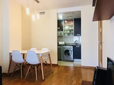 a kitchen with a table and chairs in a room at Sun Apartament Valencia @ City Arts & Sciences + Parking in Valencia