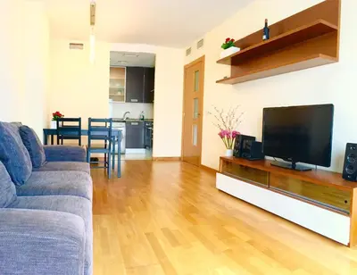 a living room with a couch and a flat screen tv at Sun Apartament Valencia @ City Arts & Sciences + Parking in Valencia