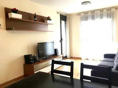 a living room with a couch and a television at Sun Apartament Valencia @ City Arts & Sciences + Parking in Valencia