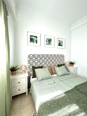 a bedroom with a bed and two night stands at Big spacious penthouse next to the sea in Valencia
