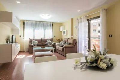 a kitchen with white counters and a white refrigerator at ApartUP Mestalla Home in Valencia