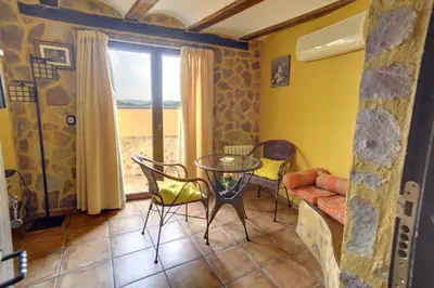 a living room with a glass table and chairs at Casa Rural Mirador del Salto in Chella