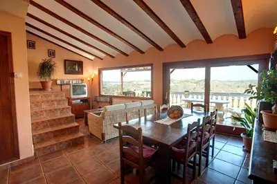 a dining room with a table and chairs at Casa Rural Mirador del Salto in Chella