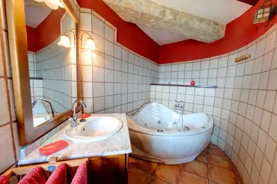 a bathroom with a tub and a toilet and a sink at Casa Rural Mirador del Salto in Chella