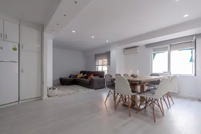 a kitchen and living room with a table and chairs at Carmen Apartment in Valencia