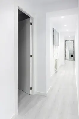 an empty corridor with a door in a white room at Carmen Apartment in Valencia