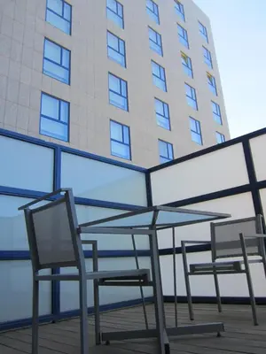 two chairs and a table in front of a building at Primus Valencia in Valencia