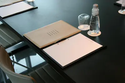 a table with a book and a bottle on it at Primus Valencia in Valencia
