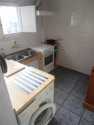 a small kitchen with a sink and a washing machine at Apartment 400 meters from the beach in Valencia