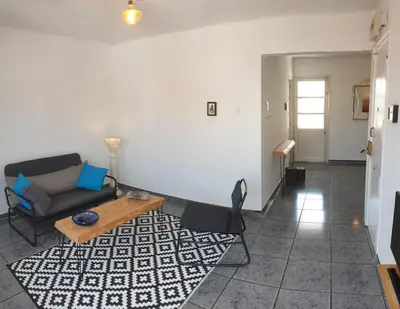 a living room with a couch and a table at Apartment 400 meters from the beach in Valencia