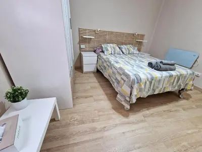 a bedroom with a bed and a wooden floor at Vive Valencia con playa y metro cerca in Valencia