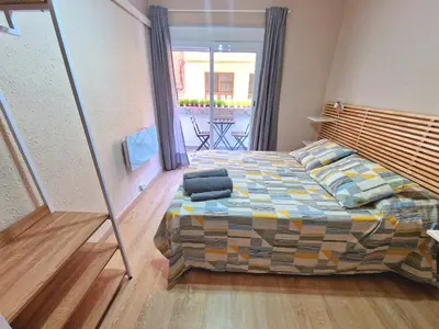 a bedroom with a bed with pillows on it at Vive Valencia con playa y metro cerca in Valencia