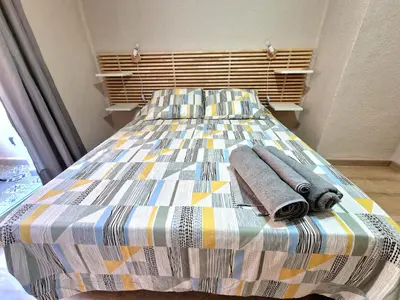 a bed with towels on it in a bedroom at Vive Valencia con playa y metro cerca in Valencia