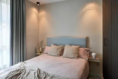 a bedroom with two beds and a wooden door at Citizentral Gascons in Valencia