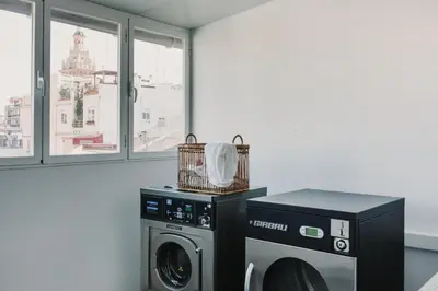 a kitchen with stainless steel appliances and a table at Citizentral Gascons in Valencia