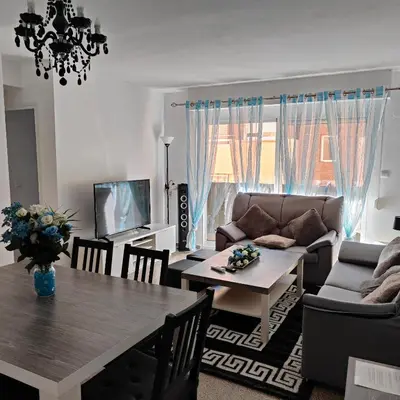 a living room with a table and a couch at Relaxed Space in the beach in Puerto de Sagunto