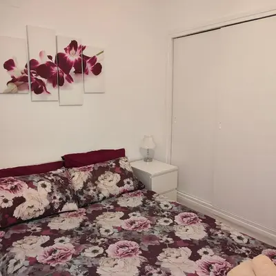 a bedroom with a bed with flowers on it at Relaxed Space in the beach in Puerto de Sagunto